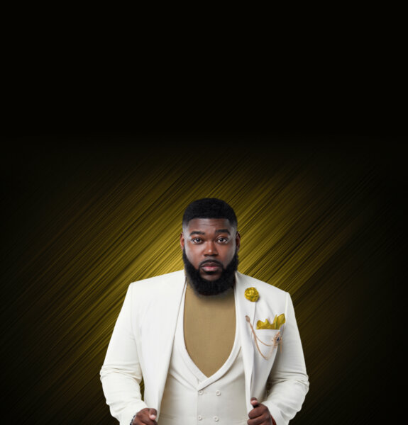 Atty Joshua Palmer in a cream suit poses confidently against a dark background with gold diagonal streaks