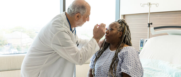 A doctor examines a patient with a brain injury
