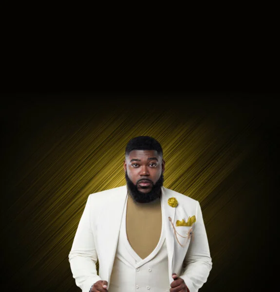 Atty Joshua Palmer in a cream suit poses confidently against a dark background with gold diagonal streaks